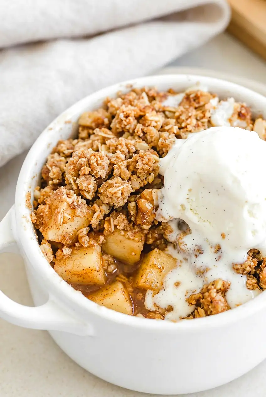 Close-up of air fryer apple crisp showing tender spiced apples and crisp browned topping