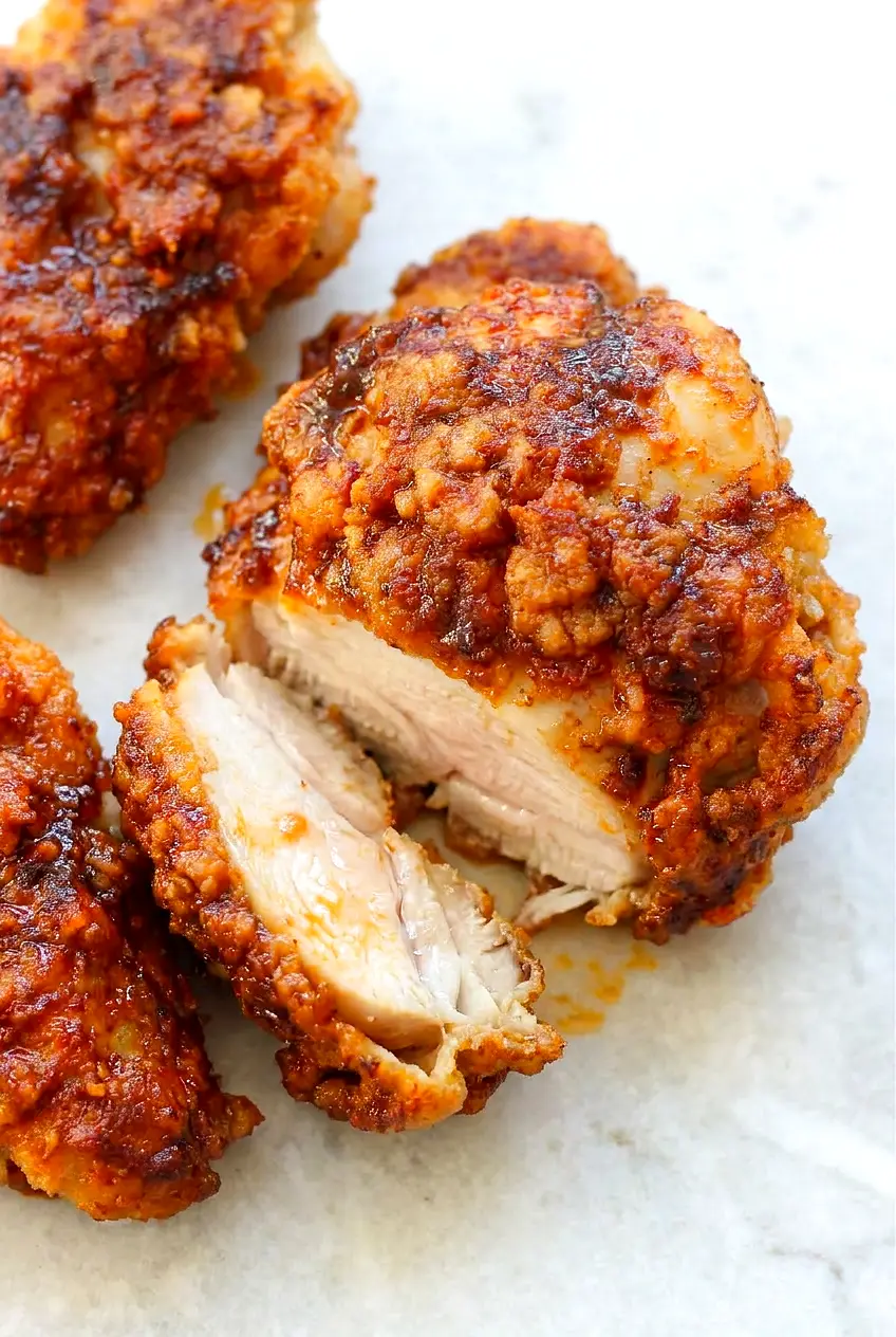 Close-up of Air Fryer Nashville hot chicken thighs showing the crisp coating and spicy glaze