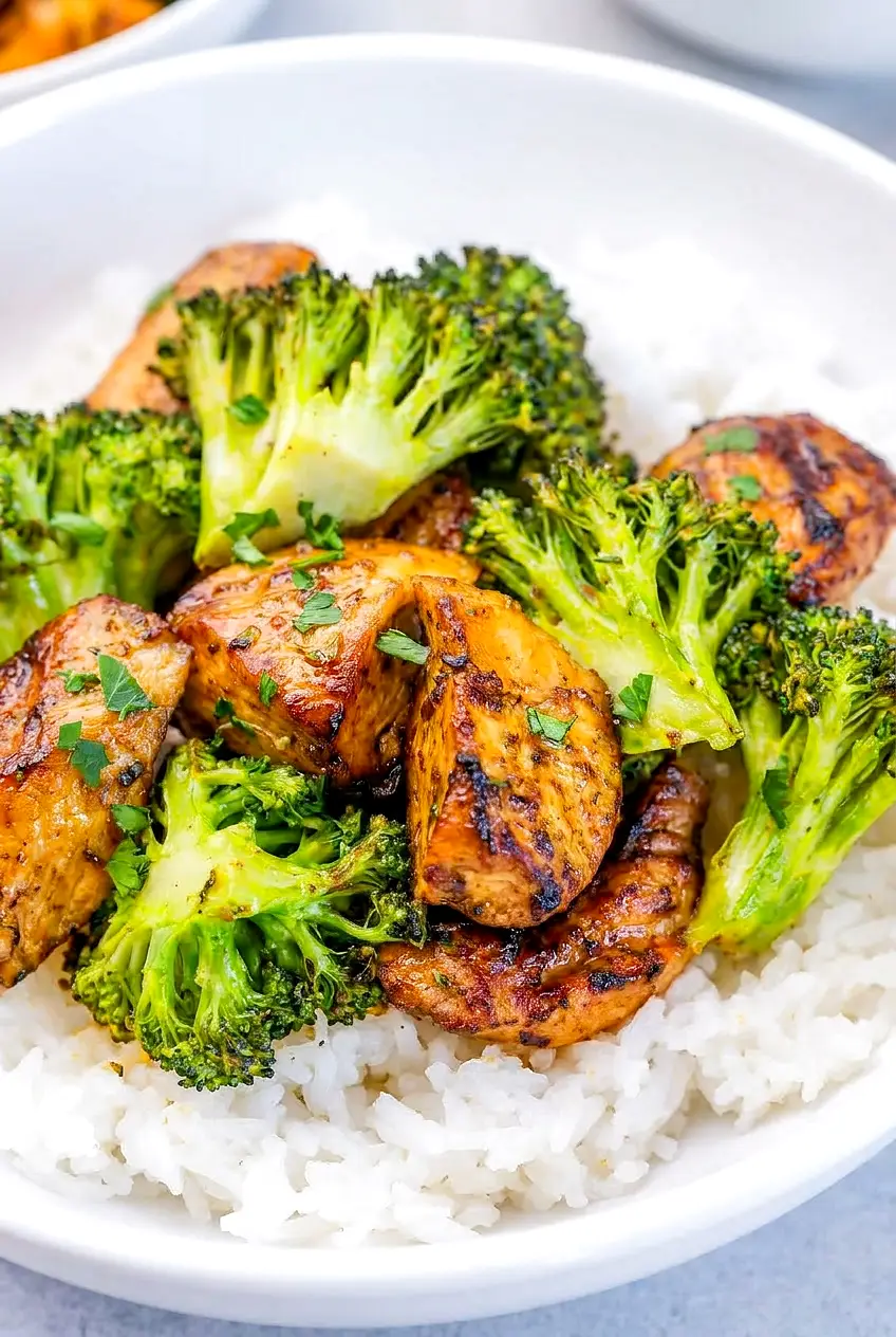 Close-up of air fryer chicken bites and broccoli with glossy maple-soy glaze
