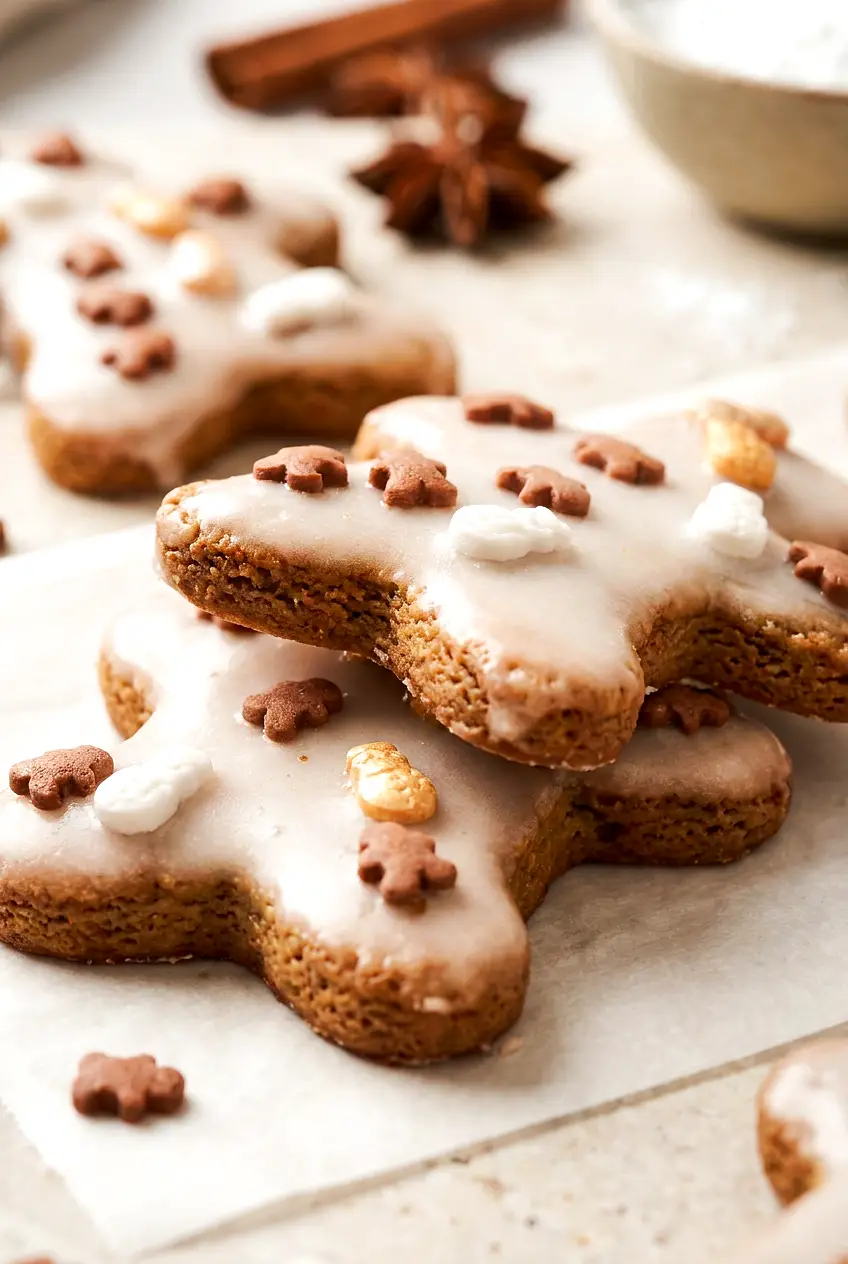 Close-up of Air Fryer Christmas Cookies with soft centers, lightly browned edges, vanilla icing, and sprinkles